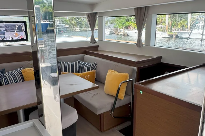 Keola Yacht Photos Pics Interior of 2022 Lagoon 40 catamaran with cozy seating and large windows.