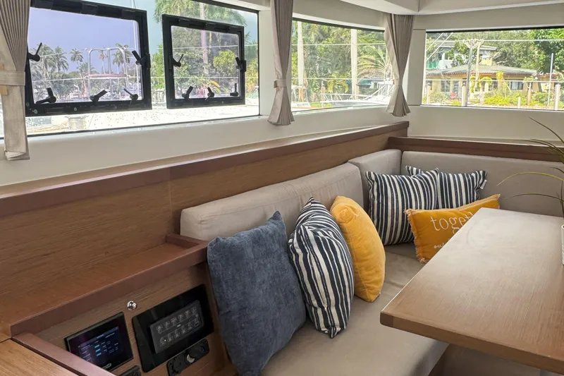 Keola Yacht Photos Pics Interior of 2022 Lagoon 40 yacht with cozy seating and decorative pillows.