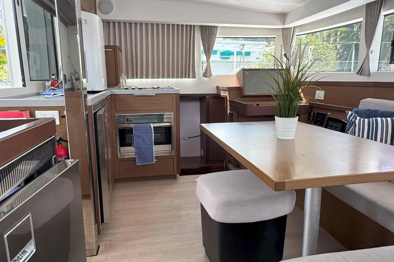 Keola Yacht Photos Pics Modern interior of 2022 Lagoon 40 catamaran with kitchen and dining area.