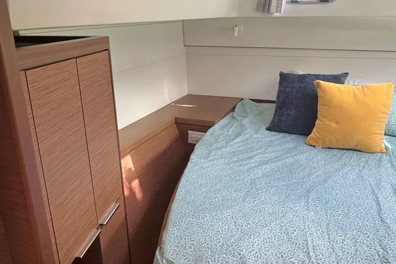 Keola Yacht Photos Pics Cozy cabin interior of 2022 Lagoon 40 catamaran with bed and pillows.