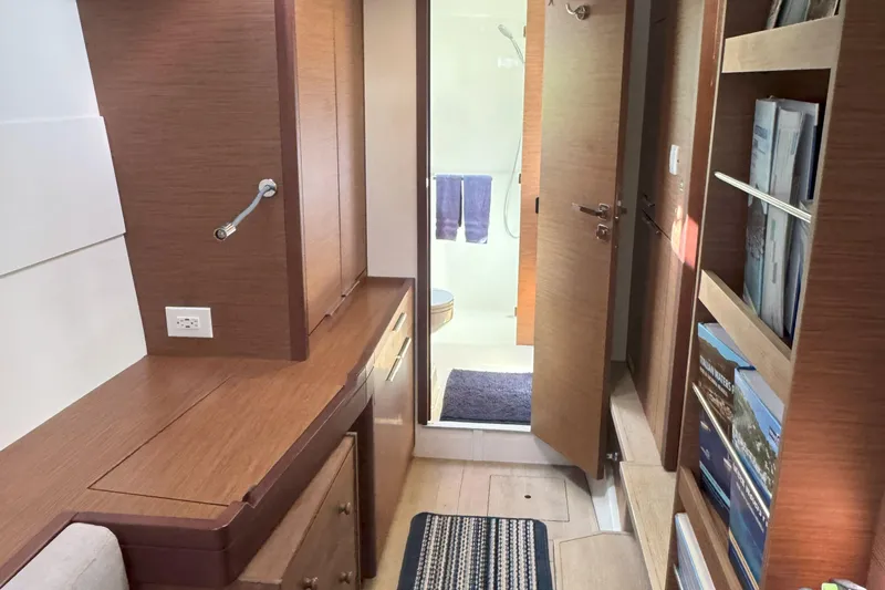 Keola Yacht Photos Pics Interior of 2022 Lagoon 40 yacht with wooden cabinetry and bathroom view.