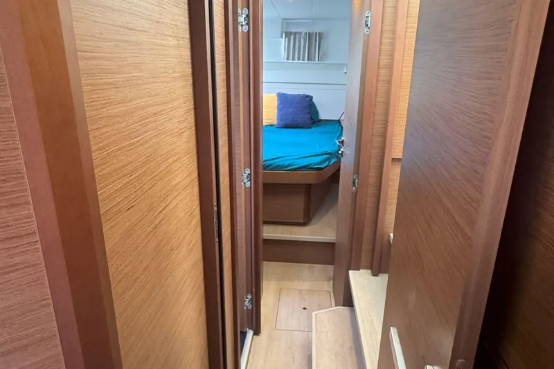 Keola Yacht Photos Pics Interior of 2022 Lagoon 40 yacht, featuring a cozy cabin with wooden finishes.