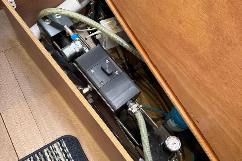 Keola Yacht Photos Pics Engine compartment of a 2022 Lagoon 40 catamaran, showcasing mechanical components and hoses.