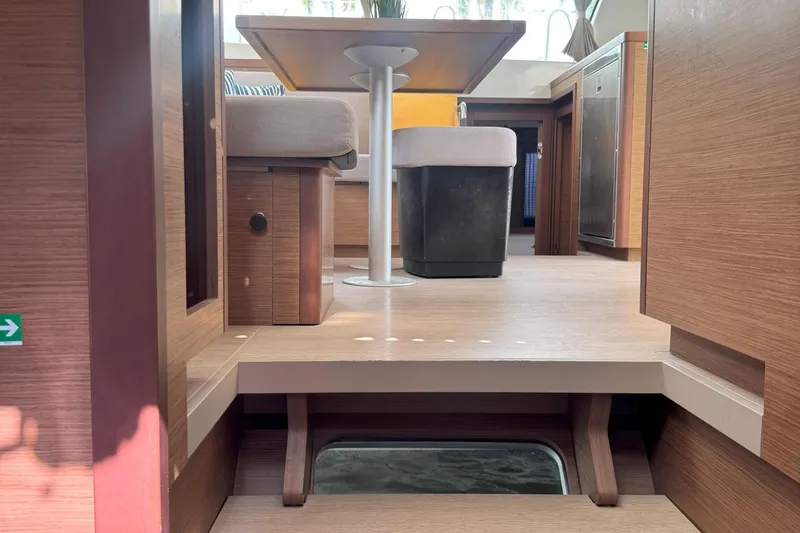 Keola Yacht Photos Pics Interior of 2022 Lagoon 40 catamaran, featuring modern wood finish and seating area.