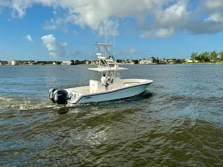 Cheers Yacht Photos Pics 2020 Invincible 33 Open Fisherman boat cruising on a sunny day.