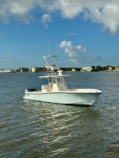 Cheers Yacht Photos Pics 2020 Invincible 33 Open Fisherman boat on calm waters under a blue sky.