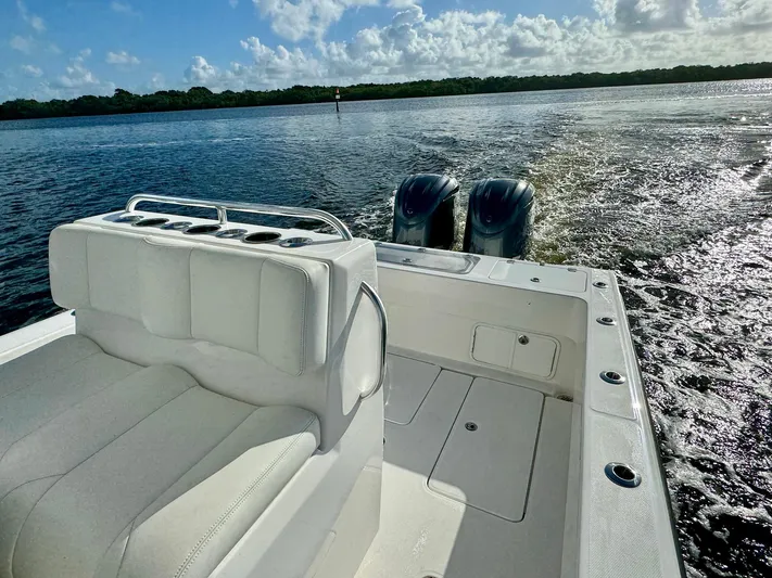 Cheers Yacht Photos Pics 2020 Invincible 33 Open Fisherman boat on water, featuring dual engines and white seating.