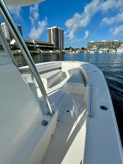 Cheers Yacht Photos Pics 2020 Invincible 33 Open Fisherman boat docked in a marina with cityscape background.
