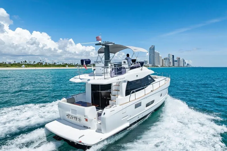  Yacht Photos Pics Azimut Magellano 43 yacht cruising near a city skyline, 2021 model.