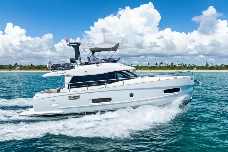  Yacht Photos Pics 2021 Azimut Magellano 43 yacht cruising on blue ocean under clear sky.