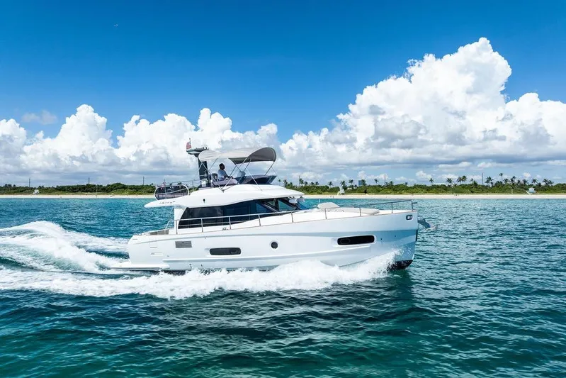  Yacht Photos Pics 2021 Azimut Magellano 43 yacht cruising on clear blue waters under a bright sky.