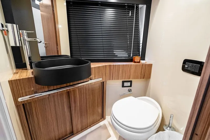  Yacht Photos Pics Luxurious bathroom in 2021 Azimut Magellano 43 yacht with modern fixtures and wood accents.