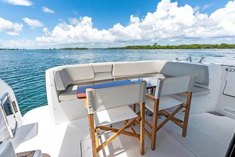  Yacht Photos Pics Azimut Magellano 43 yacht deck with seating area, overlooking serene ocean view.