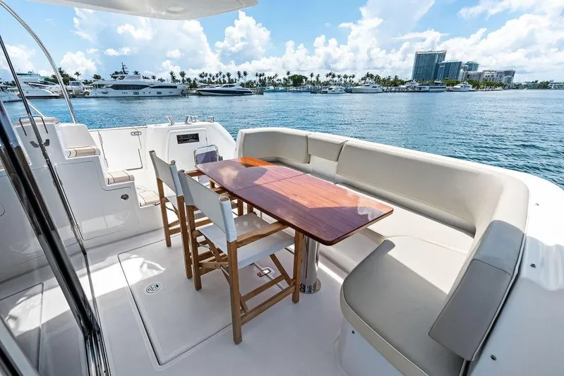  Yacht Photos Pics Luxurious Azimut Magellano 43 yacht deck with seating, table, and ocean view, 2021 model.