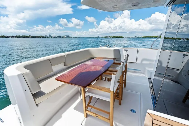  Yacht Photos Pics Azimut Magellano 43 yacht deck, 2021 model, featuring elegant seating and ocean view.