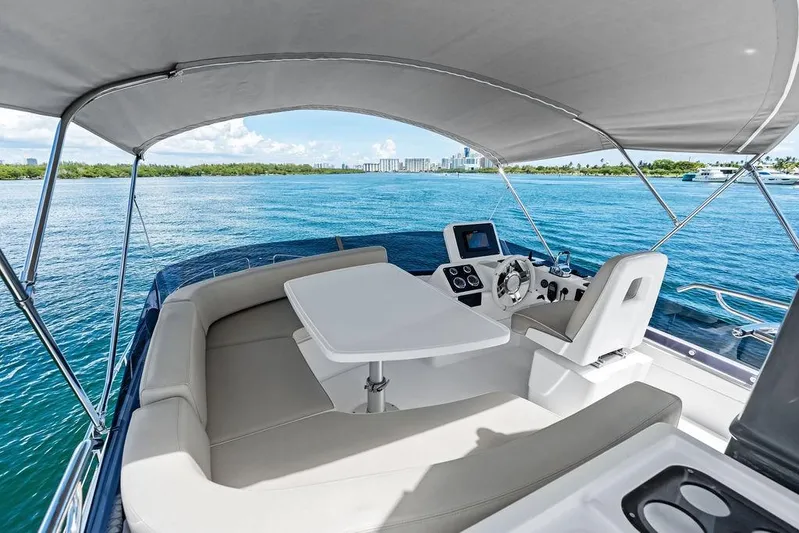  Yacht Photos Pics 2021 Azimut Magellano 43 yacht interior with helm, seating, and ocean view.