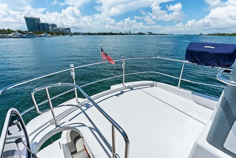  Yacht Photos Pics Azimut Magellano 43 yacht deck overlooking serene ocean and cityscape, 2021 model.