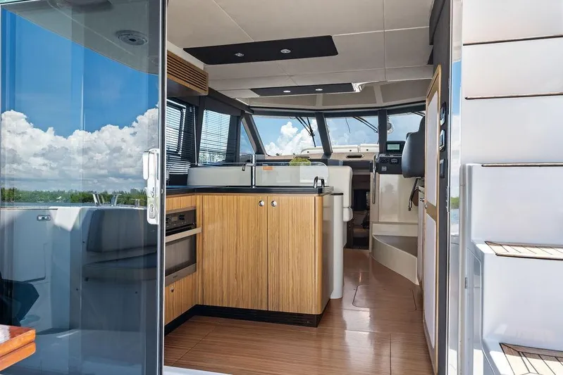  Yacht Photos Pics Interior view of 2021 Azimut Magellano 43 yacht, featuring modern kitchen and helm area.