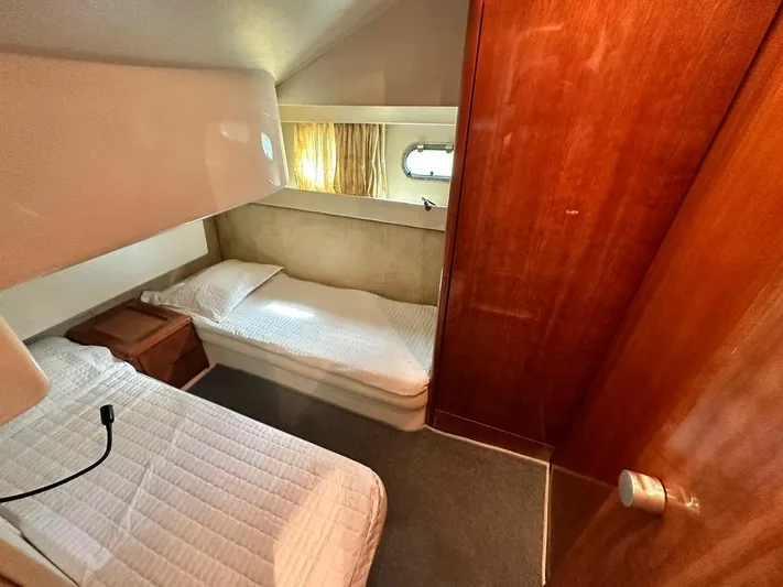  Yacht Photos Pics Interior cabin of a 1997 Azimut 43 yacht with twin beds and wooden paneling.