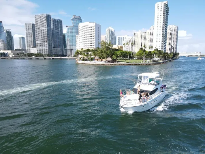  Yacht Photos Pics Azimut 43 yacht cruising near city skyline, 1997 model, on a sunny day.
