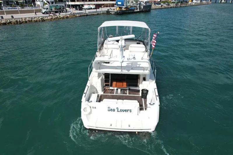  Yacht Photos Pics Azimut 43 yacht from 1997 named "Sea Lovers" cruising in clear blue waters.