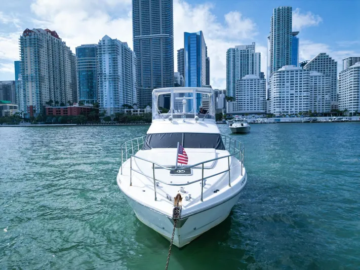  Yacht Photos Pics Azimut 43 yacht from 1997 on water with city skyline in background.