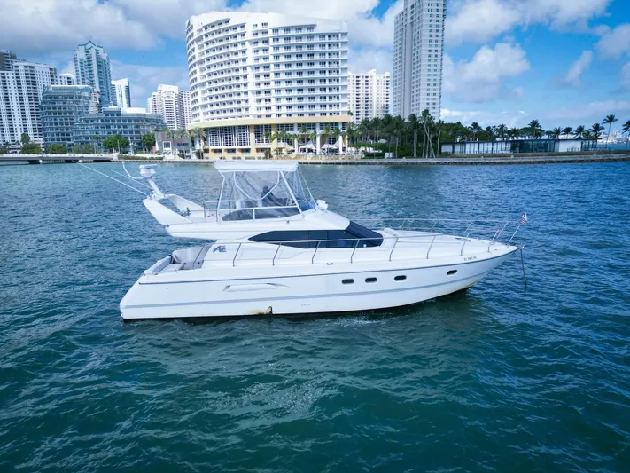  Yacht Photos Pics Azimut 43 yacht from 1997 on water with city skyline background.
