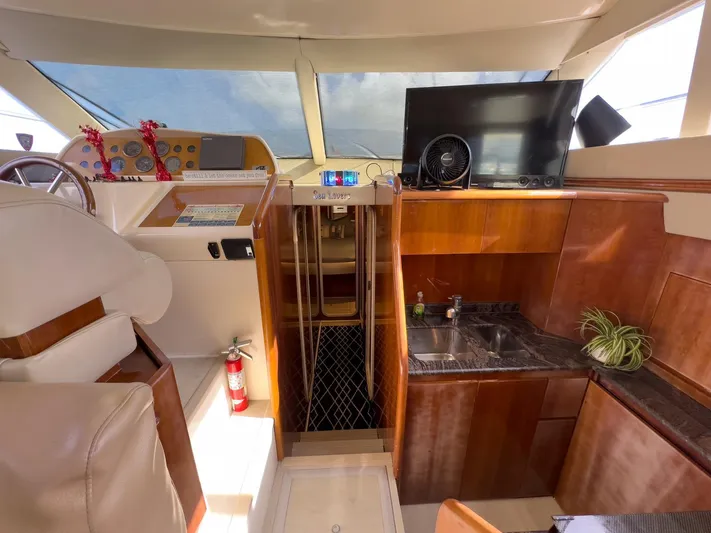  Yacht Photos Pics Interior of a 1997 Azimut 43 yacht with helm, kitchenette, and modern amenities.