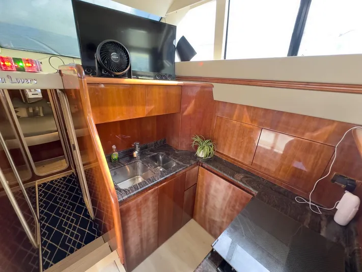 Yacht Photos Pics Interior of 1997 Azimut 43 yacht kitchen with wood finish and modern amenities.