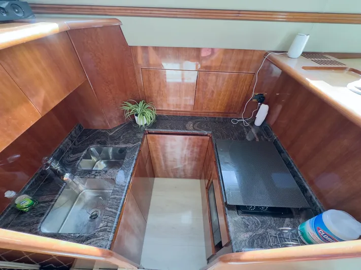  Yacht Photos Pics Luxurious kitchen interior of a 1997 Azimut 43 yacht with wood and marble finishes.