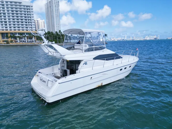  Yacht Photos Pics Azimut 43 yacht from 1997 cruising near city skyline on a sunny day.