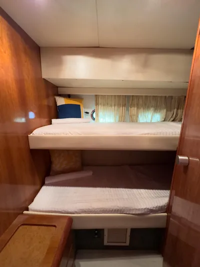  Yacht Photos Pics Interior of 1997 Azimut 43 yacht with wooden bunk beds and cozy decor.