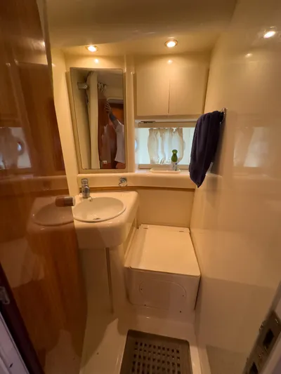  Yacht Photos Pics Bathroom interior of a 1997 Azimut 43 yacht, featuring sink, mirror, and storage.
