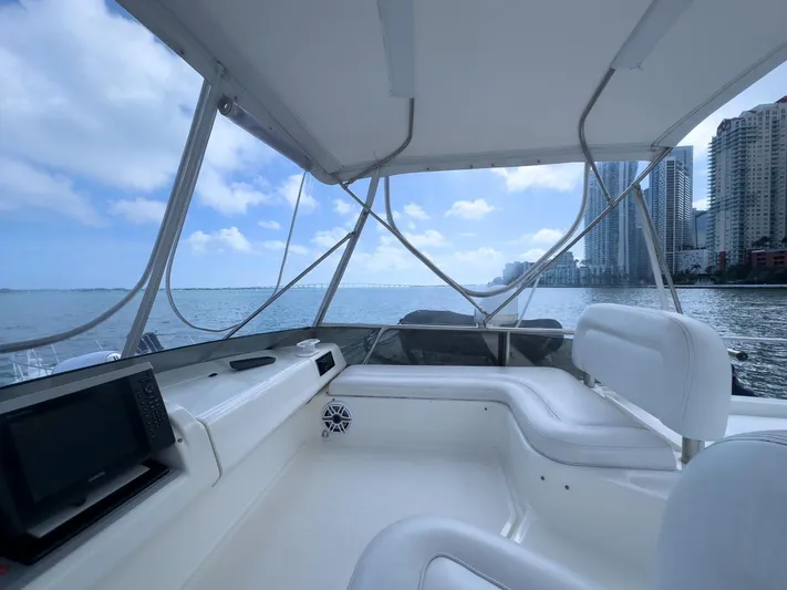  Yacht Photos Pics Interior view of 1997 Azimut 43 yacht with city skyline and ocean backdrop.