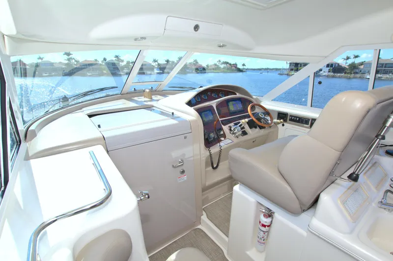 You, Me And The Sea Yacht Photos Pics 2003 Sea Ray 480 Motor Yacht helm with navigation controls and waterfront view.