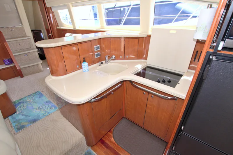You, Me And The Sea Yacht Photos Pics 2003 Sea Ray 480 Motor Yacht kitchen with wood cabinetry and modern appliances.
