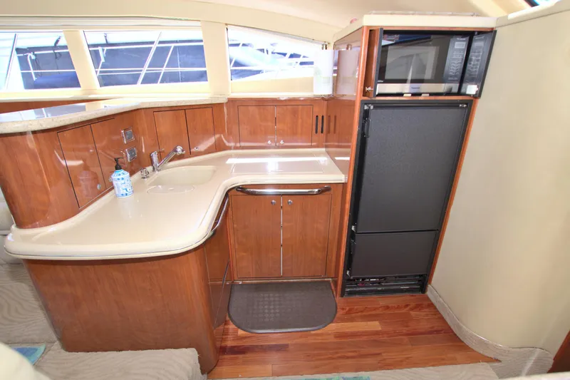 You, Me And The Sea Yacht Photos Pics Luxurious 2003 Sea Ray 480 Motor Yacht kitchen with wood cabinetry and modern appliances.