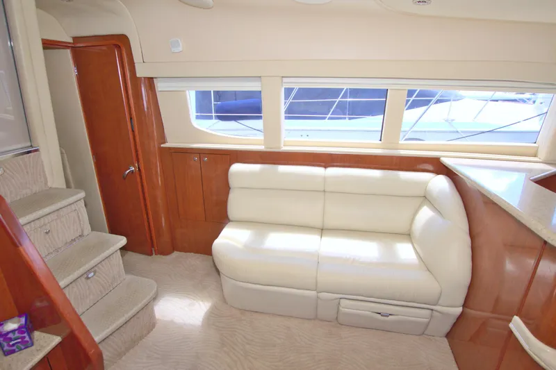 You, Me And The Sea Yacht Photos Pics Interior of 2003 Sea Ray 480 Motor Yacht with cream leather sofa and wooden cabinetry.