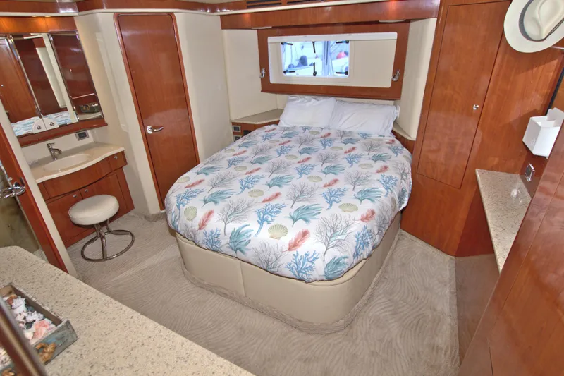 You, Me And The Sea Yacht Photos Pics Luxurious 2003 Sea Ray 480 Motor Yacht bedroom with elegant wood finishes and cozy bedding.
