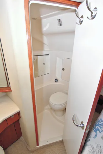 You, Me And The Sea Yacht Photos Pics 2003 Sea Ray 480 Motor Yacht bathroom with toilet, mirror, and storage cabinets.
