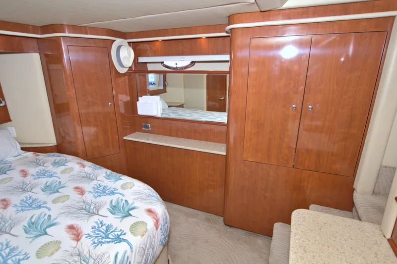 You, Me And The Sea Yacht Photos Pics Luxurious 2003 Sea Ray 480 Motor Yacht cabin with wood cabinetry and patterned bedding.