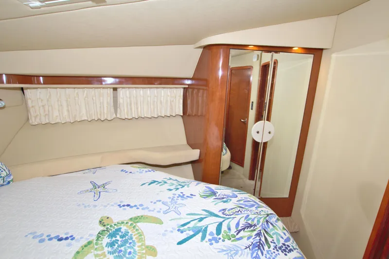 You, Me And The Sea Yacht Photos Pics Interior of 2003 Sea Ray 480 Motor Yacht with floral bedding and wooden accents.