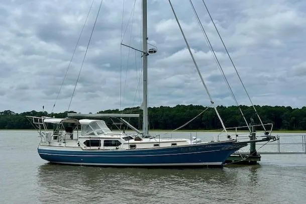 Blue Moon Yacht Photos Pics Sailboat Gozzard 41 RC 2016 docked on a calm river under cloudy skies.