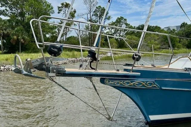 Blue Moon Yacht Photos Pics 2016 Gozzard 41 RC sailboat bow with decorative detailing, anchored near lush shoreline.