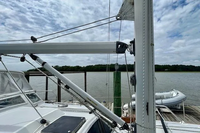 Blue Moon Yacht Photos Pics 2016 Gozzard 41 RC sailboat docked by a calm river under a cloudy sky.