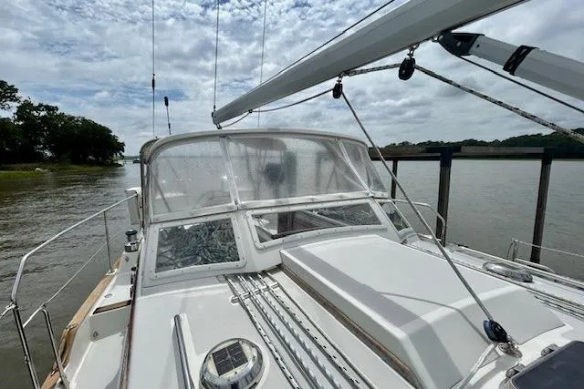 Blue Moon Yacht Photos Pics Sailboat Gozzard 41 RC, 2016 model, docked by a river under cloudy skies.