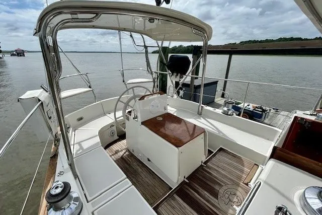 Blue Moon Yacht Photos Pics 2016 Gozzard 41 RC sailboat cockpit with steering wheel, docked by calm waters.