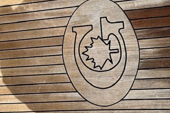 Blue Moon Yacht Photos Pics Wooden deck with engraved emblem on a 2016 Gozzard 41 RC sailboat.