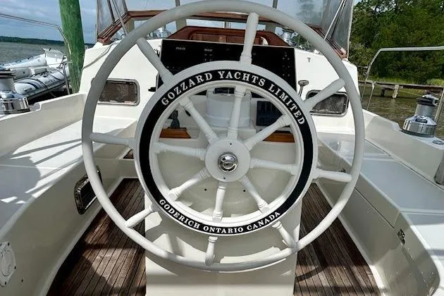 Blue Moon Yacht Photos Pics Steering wheel of 2016 Gozzard 41 RC yacht, featuring "Gozzard Yachts Limited" branding.