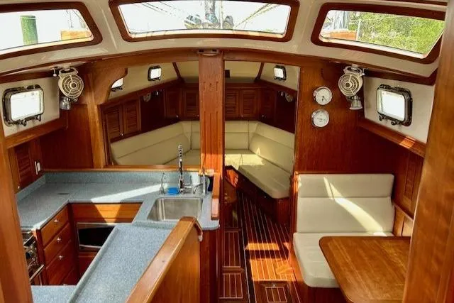 Blue Moon Yacht Photos Pics Interior of 2016 Gozzard 41 RC sailboat with wood finish and cozy seating area.